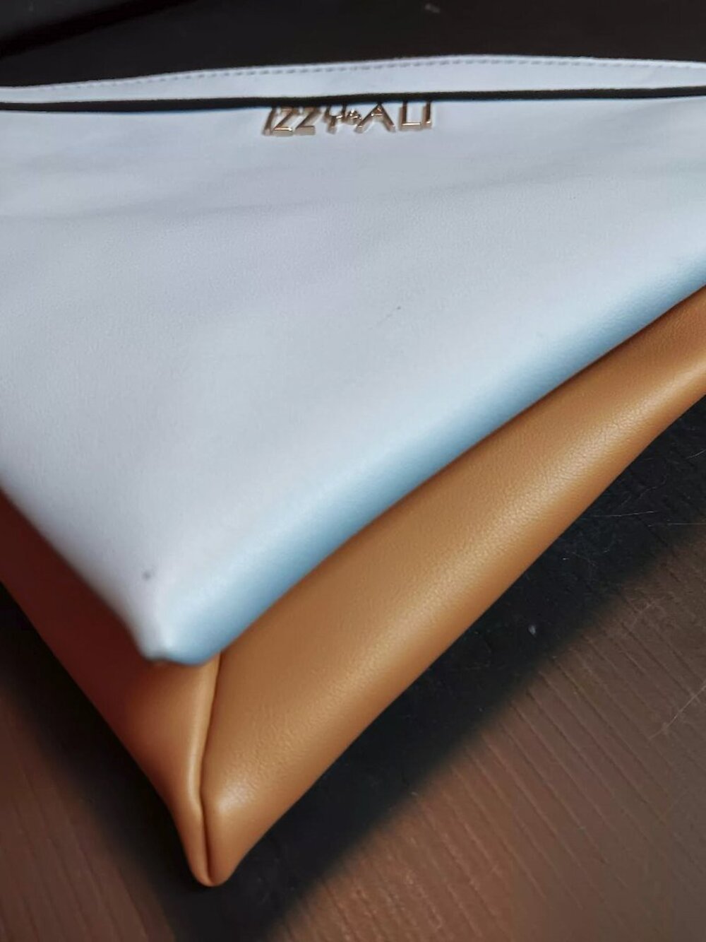 Izzy & Ali tetrahedron (envelope shaped) caramel and baby blue clutch wristlet.